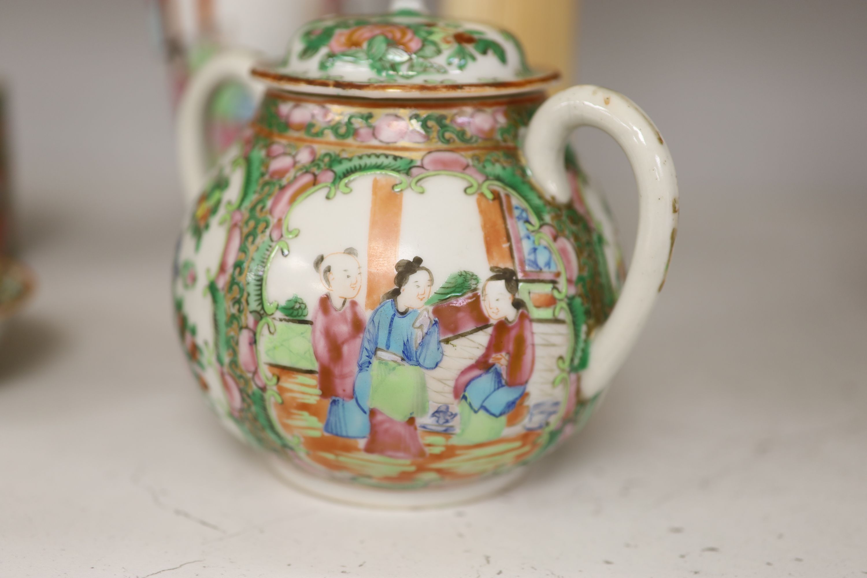 A Chinese famille rose box and cover, two vases, a sugar bowl and cover and a saucer, late 19th/early 20th century, tallest 19cm